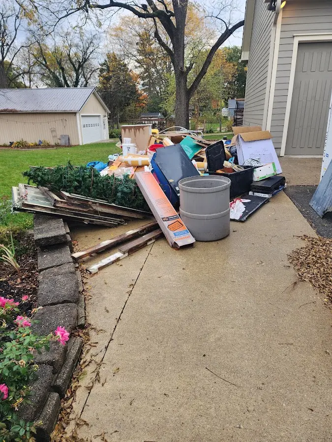 Dumpster being loaded with debris for Roofing Dumpster Rental in Saxon